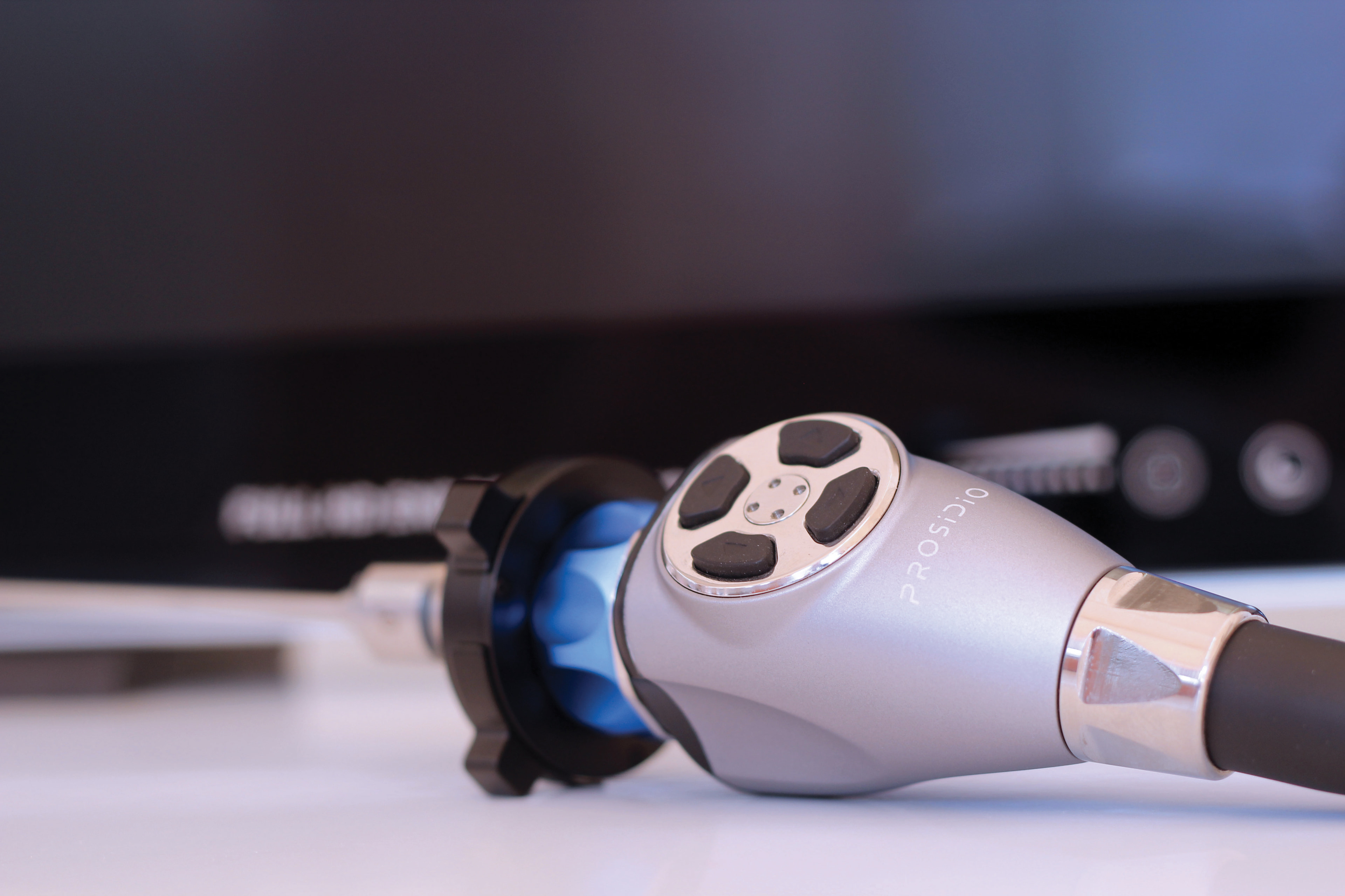 Close-up of a Prosidio camera head in front of an endoscopy display
